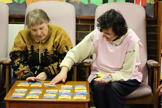 Client and carer playing cards