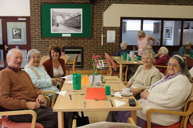 Smiling clients at the Saxon Day Centre sitting at a table